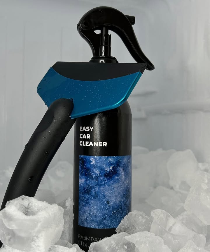 Glass defroster bottle with blue squeegee on ice