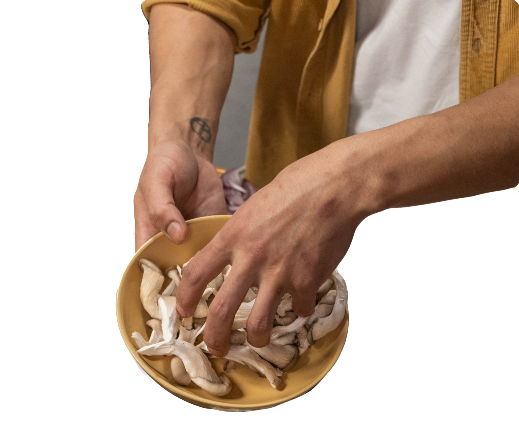 Hands lifting oyster mushrooms from a bowl